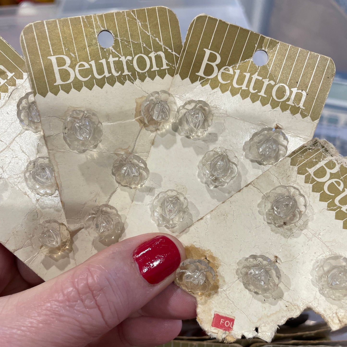 Close-up of a hand holding a package with 'Beutron' branding.