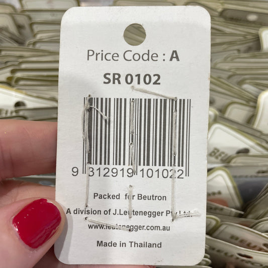 Close-up of a price tag with a barcode held by a hand.