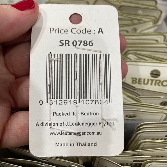 Close-up of a price tag with a barcode held by a hand, with a blurred background of similar tags.