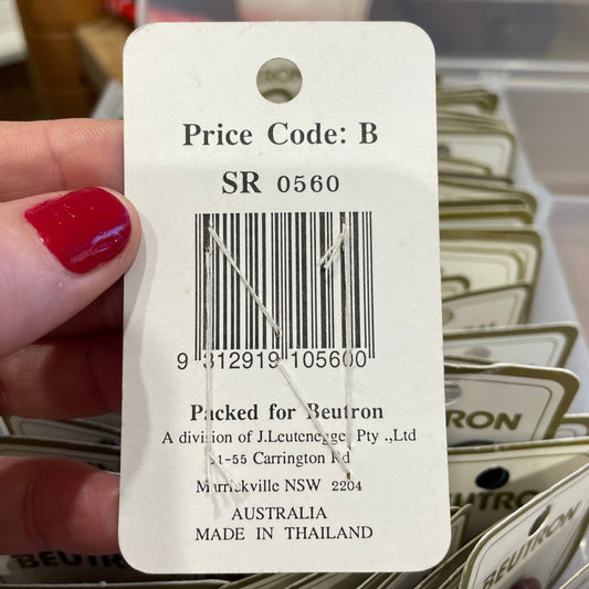 Close-up of a price tag with a barcode held by a hand.