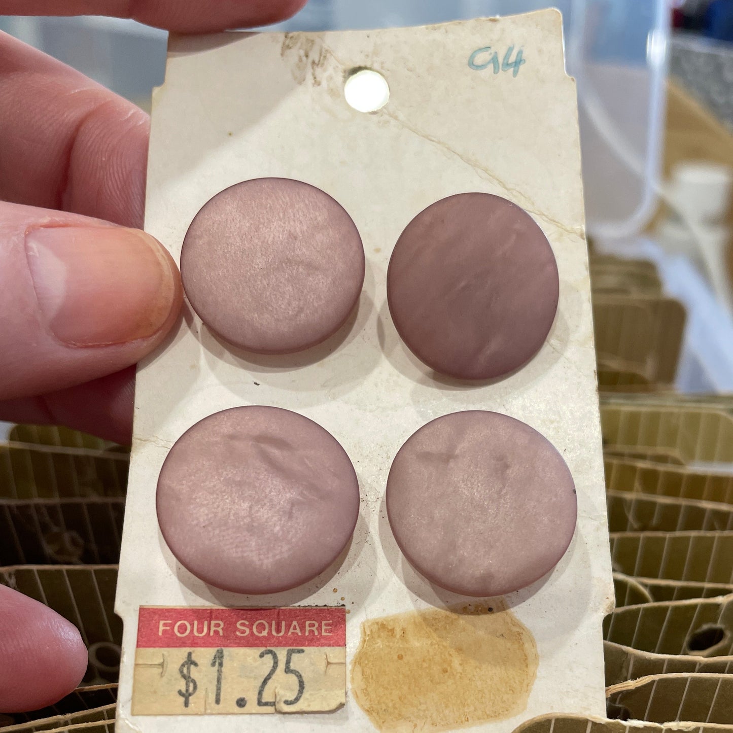 Close-up of a small package with four round buttons on a blurred background