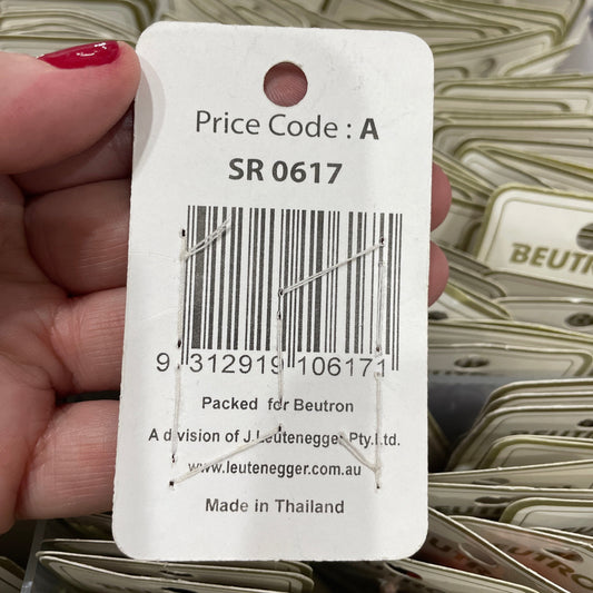 Close-up of a price tag with a barcode held by a hand, with blurred background