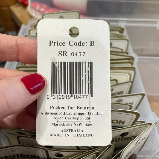 Hand holding a Neuton price tag with a barcode and product details.