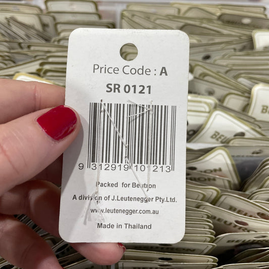 Close-up of a price tag with a barcode held by a hand.