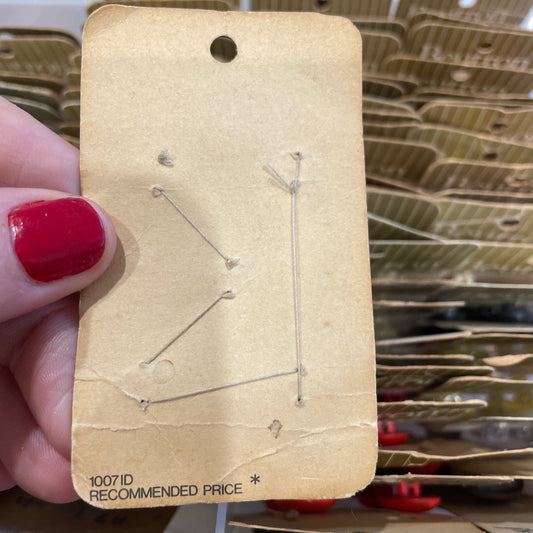 Card held by a hand with red nail polish.