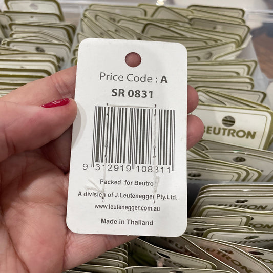 Hand holding a price tag with a barcode and text, surrounded by similar tags.