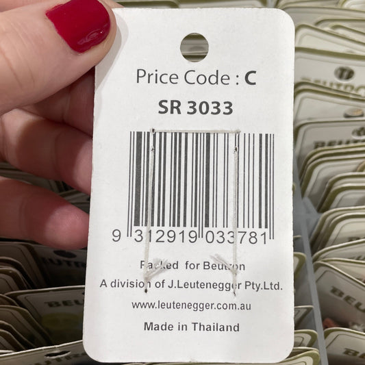 Hand holding a Beutron product tag with a barcode and text.