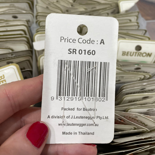 Close-up of a price tag with a barcode held by a hand.