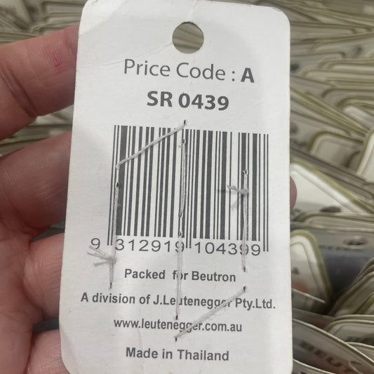 Close-up of a price tag with a barcode and text on a blurred background