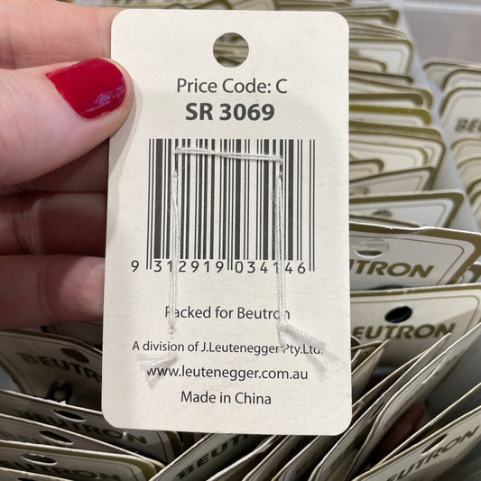 Close-up of a Leuchtturm price tag with a barcode and text, held by a hand.