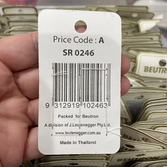 Close-up of a product tag with a barcode held by a hand, with more tags in the background.