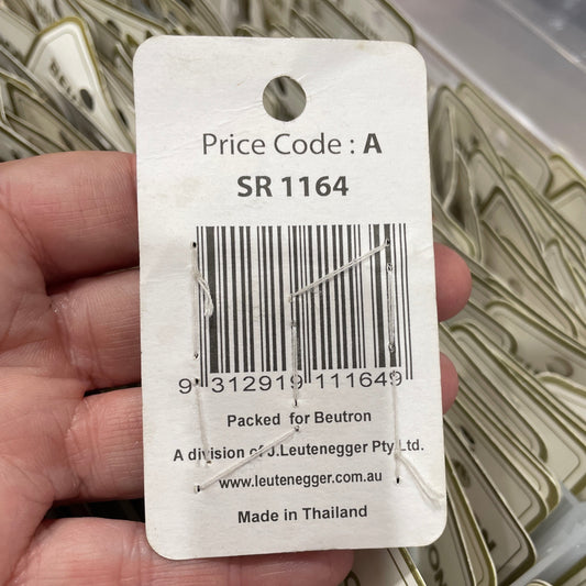 Barcode label held by a hand with blurred background