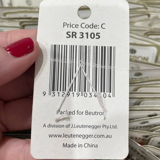Close-up of a price tag with a barcode held by a hand.