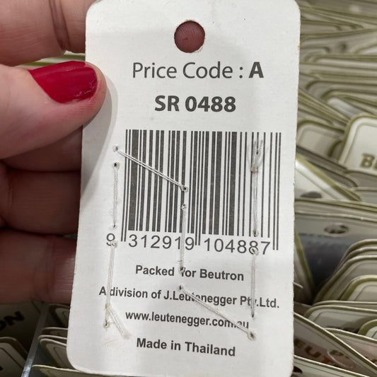 Close-up of a price tag with a barcode held by a hand.