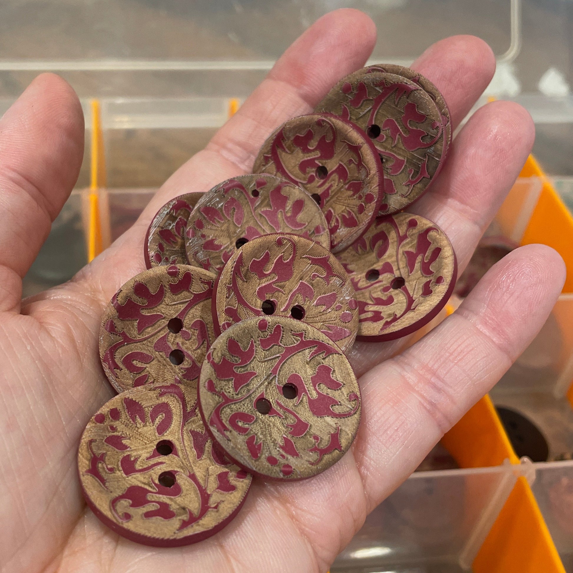 Hand holding decorative buttons with a blurred background