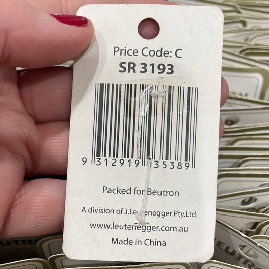 Hand holding a product tag with a barcode and 'Beurton' branding.