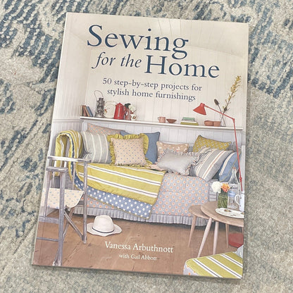 Book titled 'Sewing for the Home' on a textured surface