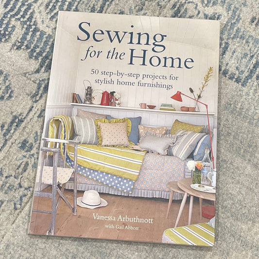Book titled 'Sewing for the Home' on a textured surface