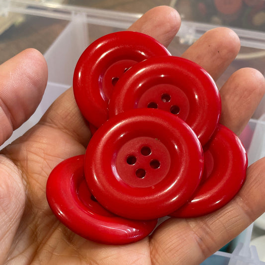 Hand holding red buttons with a blurred background
