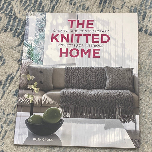 Book titled 'The Knitted Home' on a textured surface