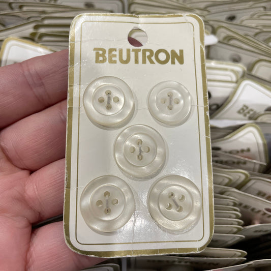 Pack of buttons with 'Beutron' branding held by a hand
