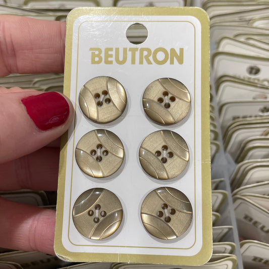 Pack of buttons held by a hand with red nail polish, brand 'Beutron' visible