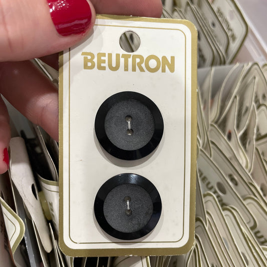 Hand holding a Beutron product with more in the background