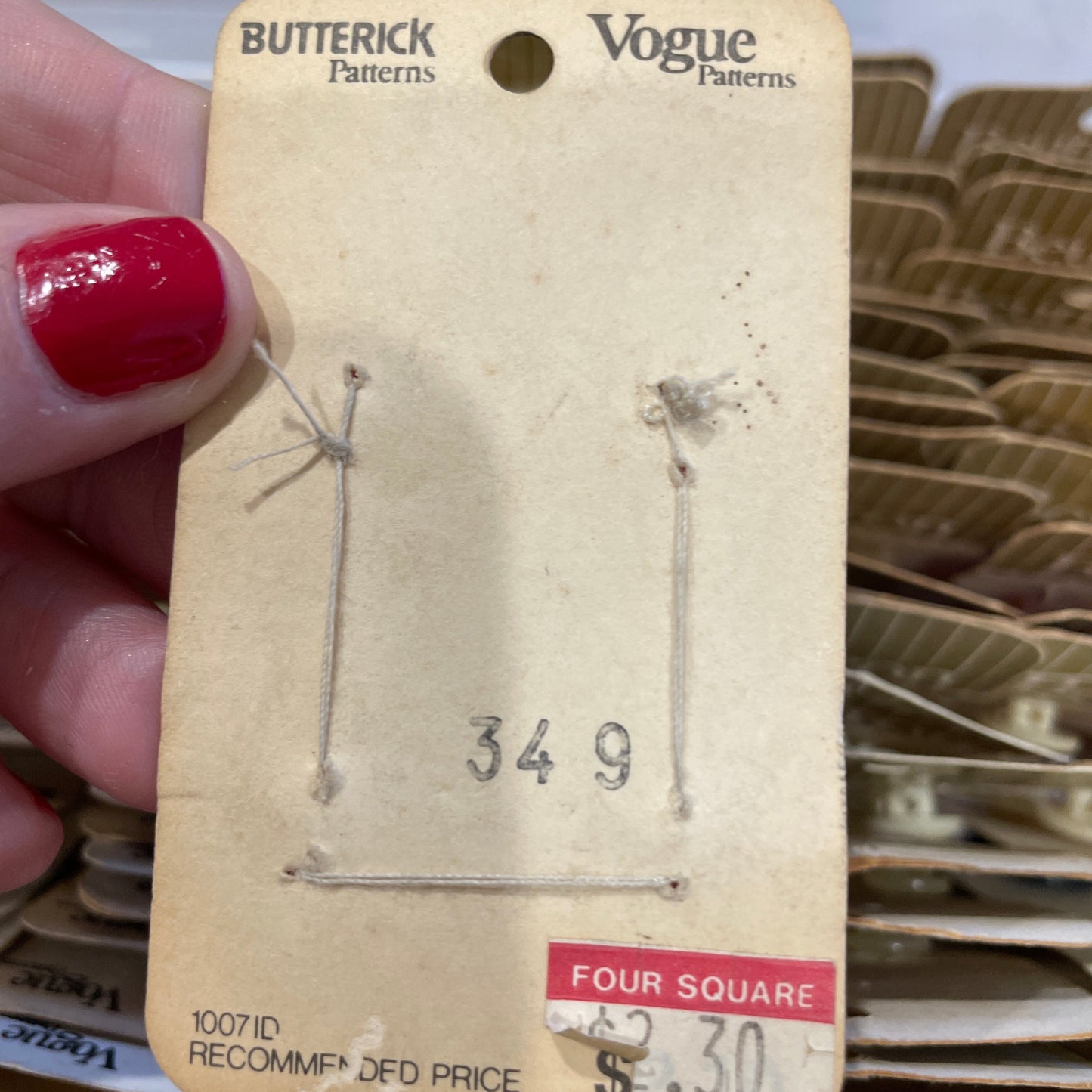 Card  held by a hand with red nail polish