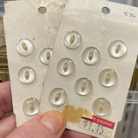 Hand holding a card with buttons against a blurred background