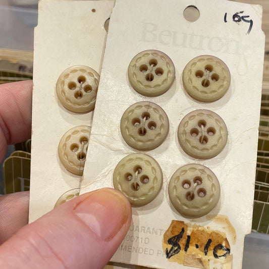Hand holding a card with buttons against a blurred background