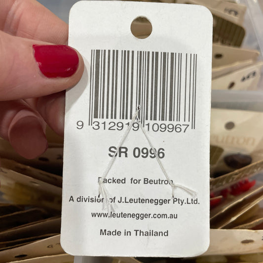 Close-up of a barcode tag held by a hand with red nail polish.