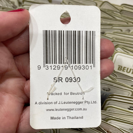 Barcode label held by a hand with blurred background