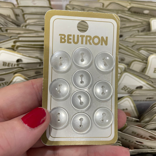 Hand holding a card with 'Beutron' branding against a background of similar cards.