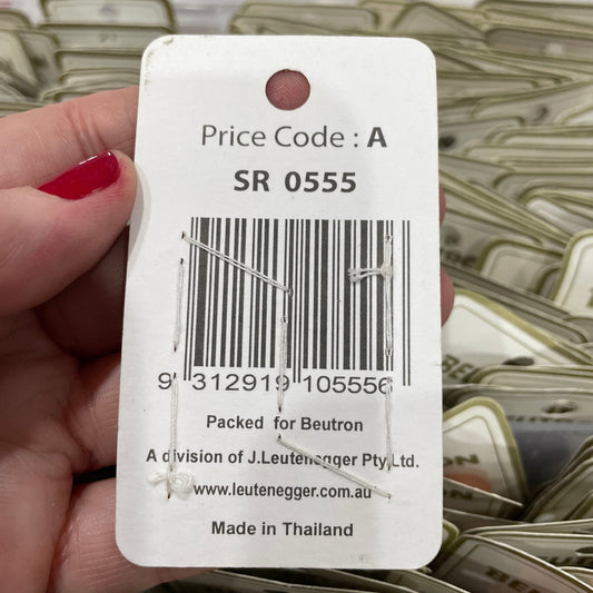 Close-up of a price tag with a barcode held by a hand.