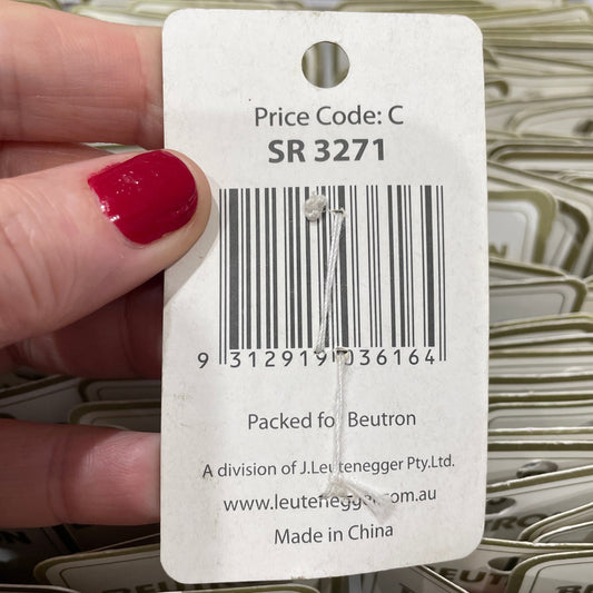 Close-up of a Neuton price tag with a hand holding it, surrounded by more price tags.