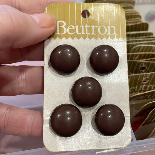 Hand holding a Beutron button card