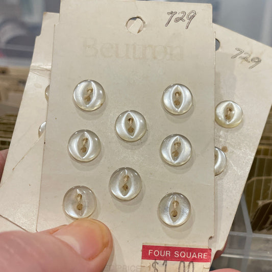Card with buttons held by a hand against a blurred background