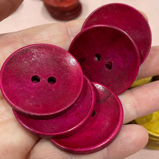Hand holding red buttons with a blurred background