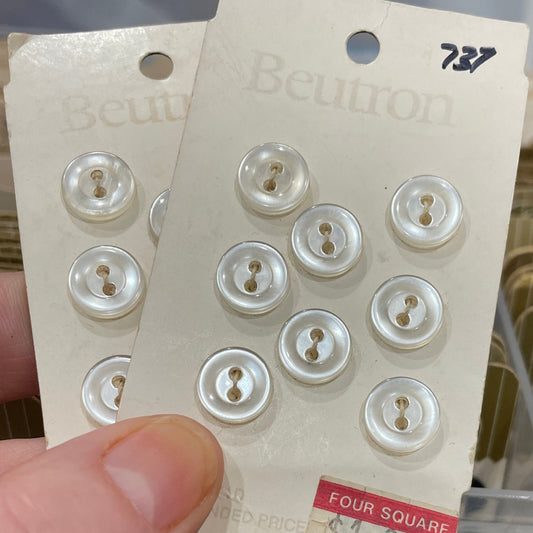 Card with buttons held by a hand, with a blurred background