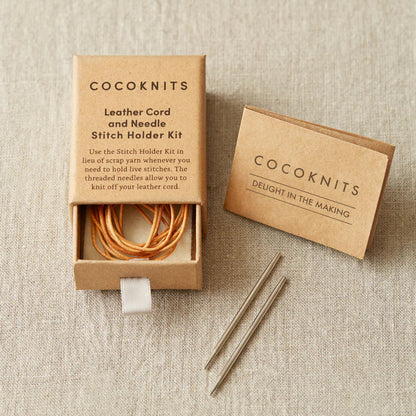 Cocoknits leather cord and needle stitch holder kit on a beige fabric background